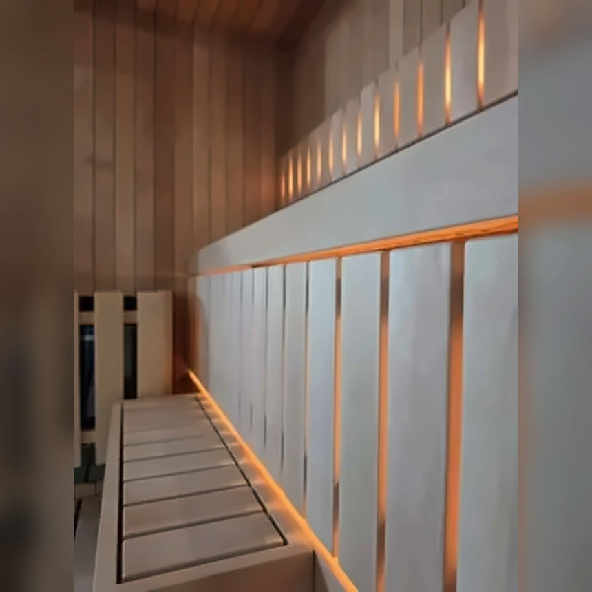 Close-up of the benches inside the Celsium Jonas Mini, with LED strips glowing under the bench edges and behind the slats