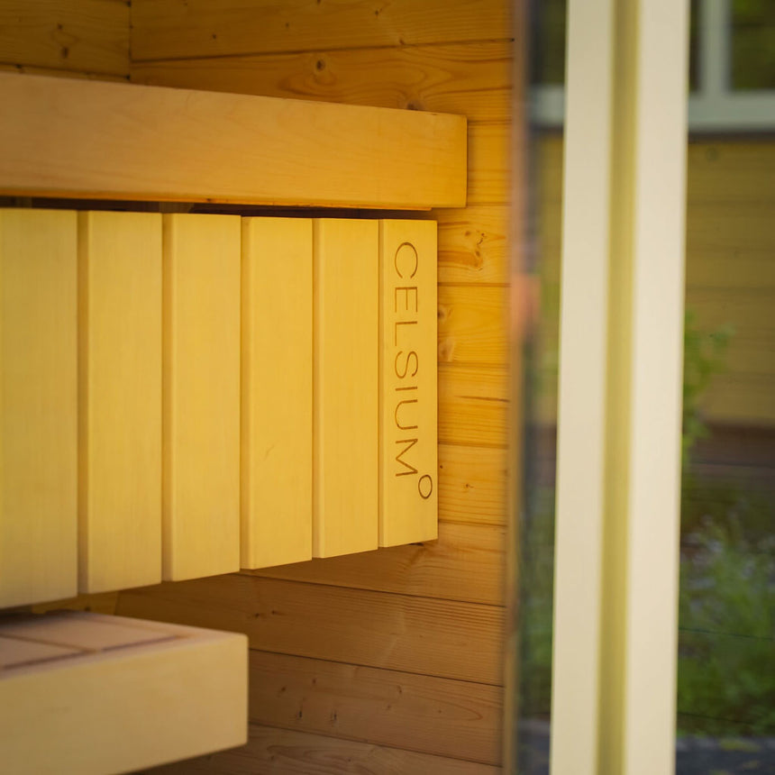 Bench backrest with the Celsium logo inside the Ula Mini, in warm light