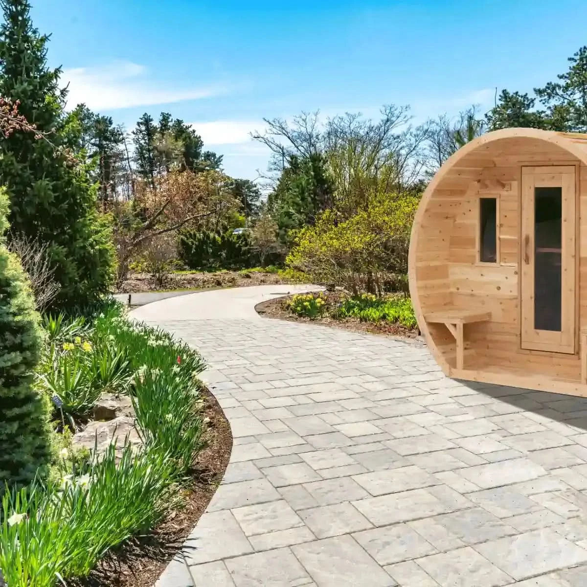 A Dundalk LeisureCraft Canadian Timber CT Elation Sauna (CTC2424E) sitting in a beautiful garden, showcasing the front exterior and wooden benches.