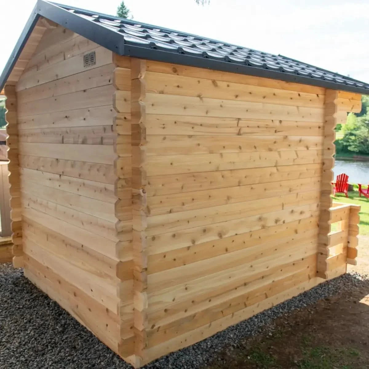 Side exterior of the Dundalk LeisureCraft Canadian Timber Georgian Cabin Sauna with Porch (CTC88PE), highlighting the cabin log walls and roof.