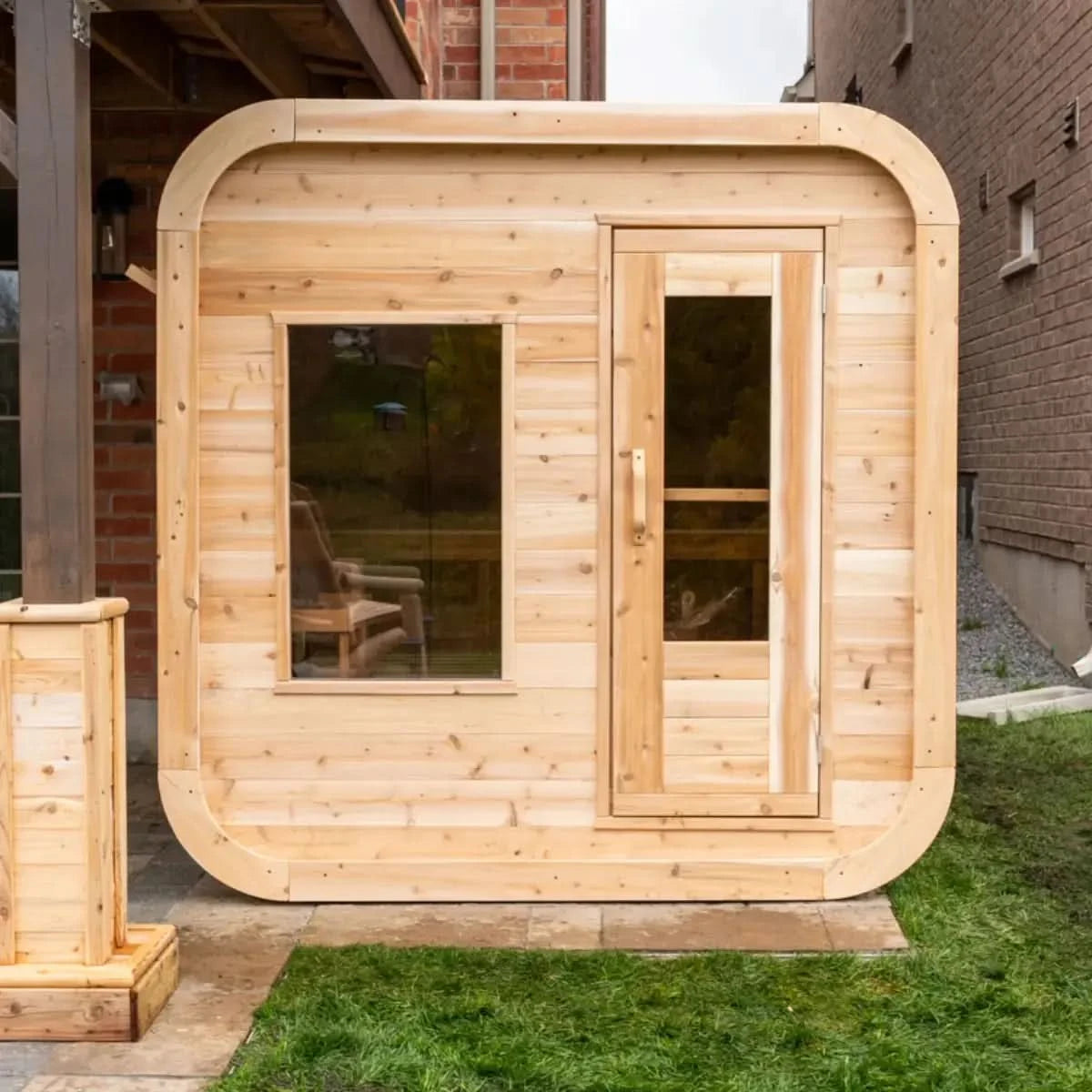 Front exterior view of a Dundalk LeisureCraft Canadian Timber Luna Sauna (CTC22LU), highlighting the rounded corners and front door.