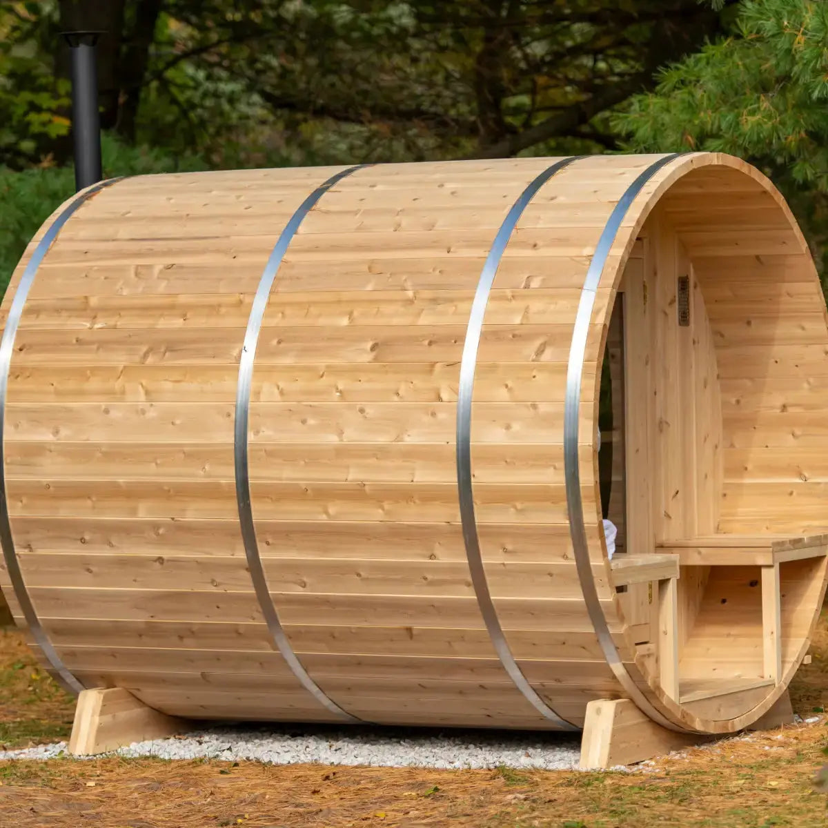 Exterior side view of the Dundalk Leisure Craft CT Serenity Barrel Sauna (CTC2245E), highlighting the classic barrel shape and the durable steel bands that secure the cedar wood staves.