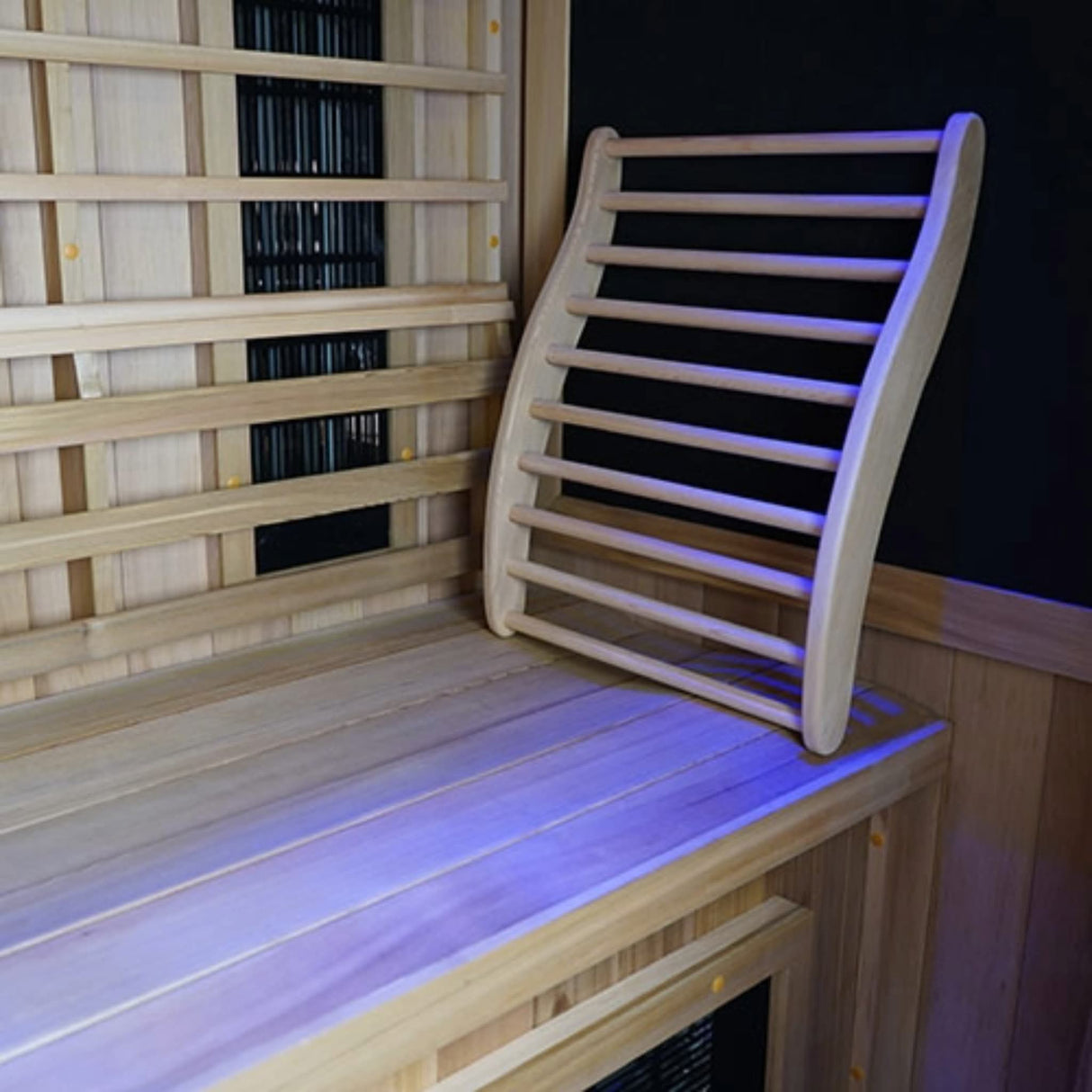 Finnmark FD-1 infrared sauna interior showing Western Canadian cedar backrest with chromotherapy blue lighting and carbon 360 heater panels.