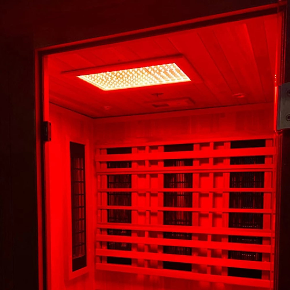 Finnmark FD-4 Trinity sauna with Spectrum Red Light Therapy and chromotherapy activated showing 650nm medical grade LED panel.