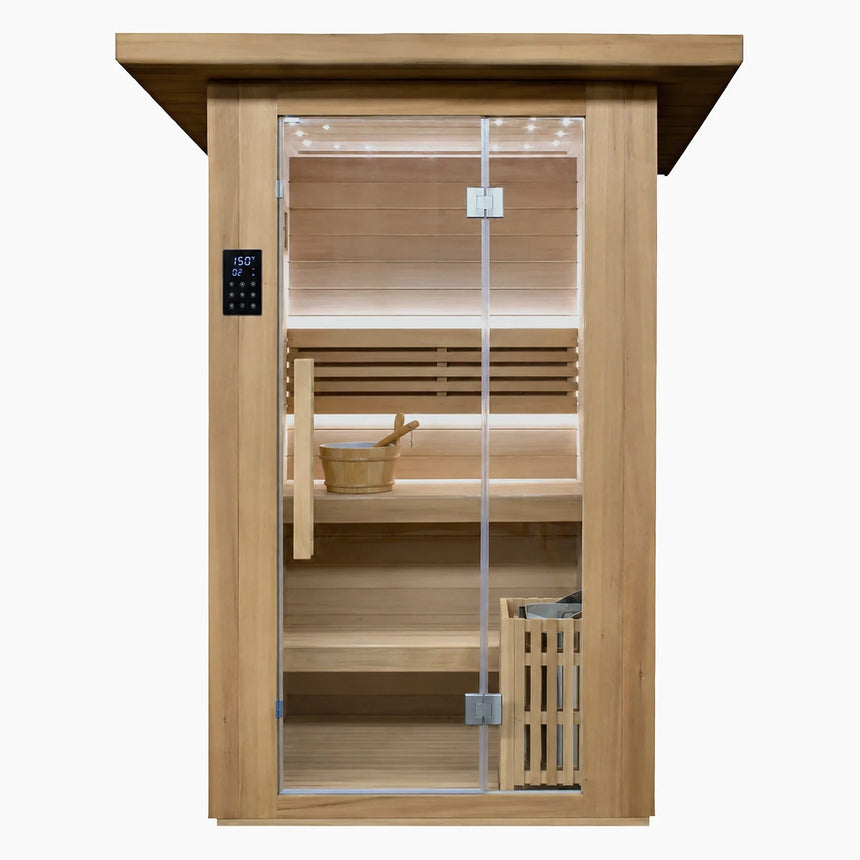 Front view of the Revive 2 Person Traditional Sauna in thermo-treated hemlock with a full-height glass door, exterior touchscreen control panel, bucket and ladle on the upper bench and the heater behind a wooden guard