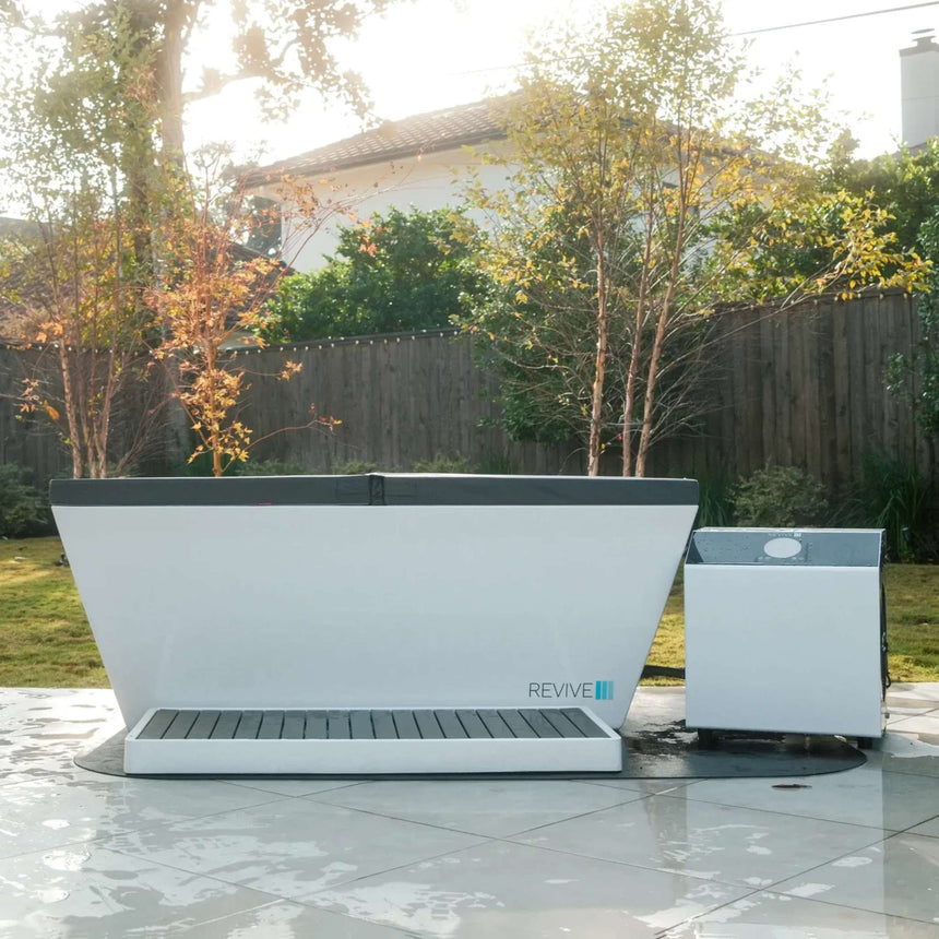 Revive Acrylic Plunge with insulated cover and chiller on a backyard patio, shown with the optional Acrylic Basin and protective mat