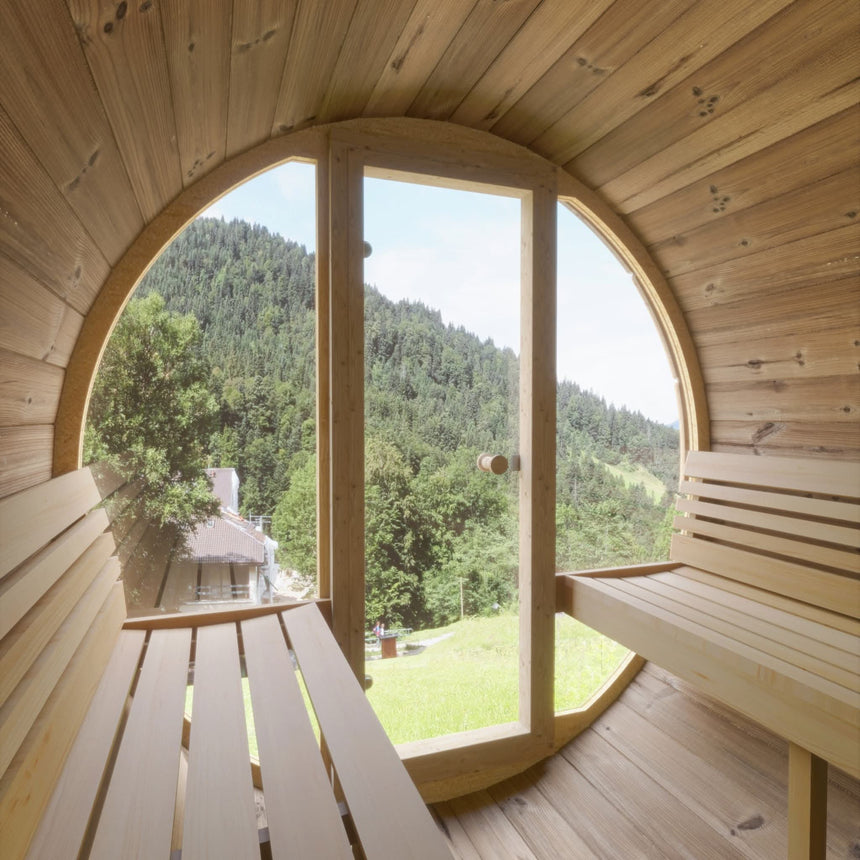 Interior view of the SaunaLife E7G showing the full glass front door and window providing a scenic outdoor view.