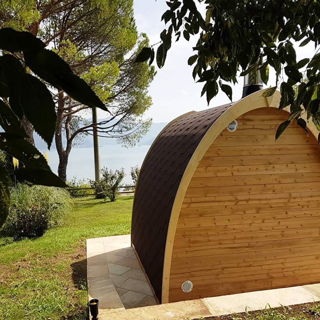 SaunaLife G3 Garden Series outdoor sauna rear view showing parabolic arched design with black shingled roof and ventilation vents.