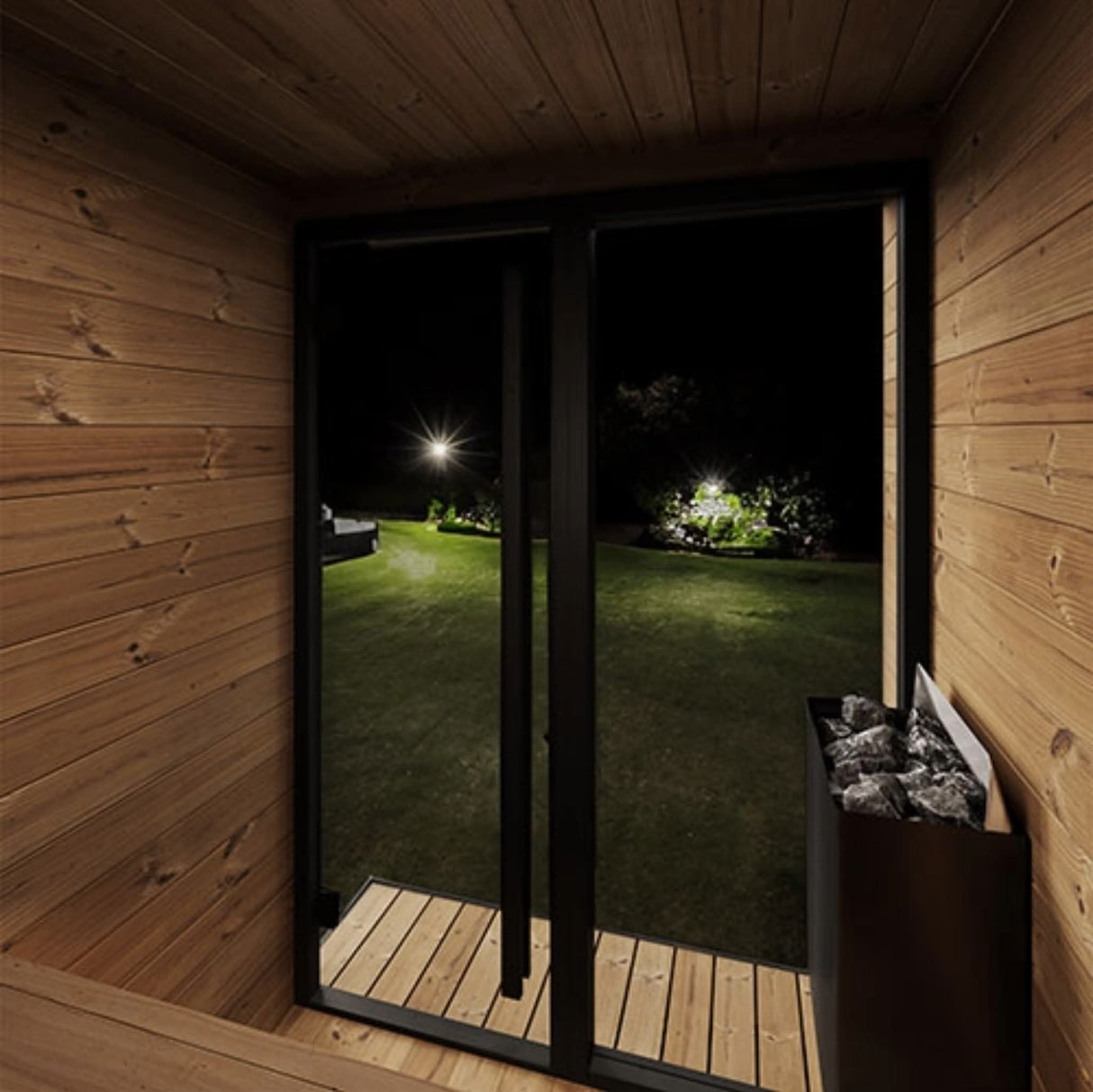 SaunaLife GL4 sauna interior at night through bronze tempered glass door with thermo-spruce walls and electric sauna heater.