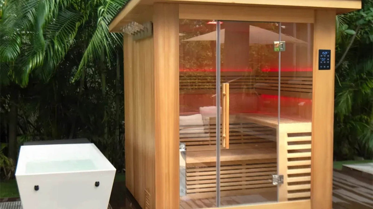 Revive saunas: the Revive 4 Person Traditional Sauna on an outdoor deck with red LED lighting inside, beside a Revive Acrylic Plunge sold separately