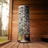 Celsium Jonas Grand interior shown with a tall stone-filled sauna heater beside the glass front