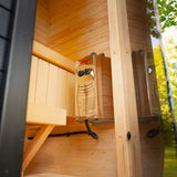 Wall-mounted sauna heater with control knobs beside the bench inside the Celsium Ula Micro Compact