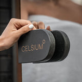 Hand gripping the black wooden Celsium door handle on the Ula Mini