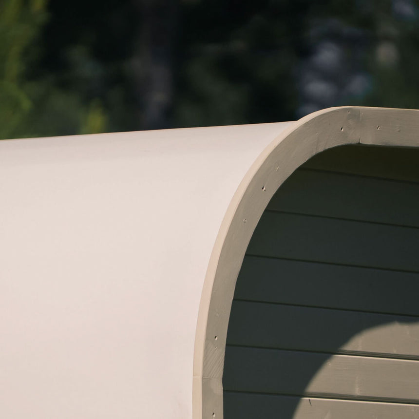 Close-up of the rounded corner on a light-colored Celsium Ula Mini outdoor sauna