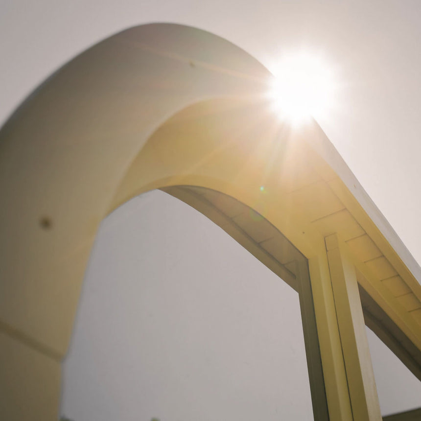 Rounded frame of the Celsium Ula Mini outdoor sauna against the sun