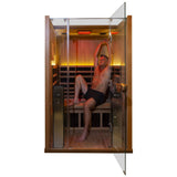 Man stretching inside Clearlight Sanctuary 2 full spectrum infrared sauna during wellness session