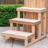 A 3-tier wooden step made from Knotty Red Cedar (SKU: 730188), designed for safe and easy access to a Cold Plunge Tub.