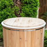 A 36-inch round, two-piece cold plunge lid (SKU: 730189) made from Knotty Red Cedar, sitting on a round wooden cold plunge tub.