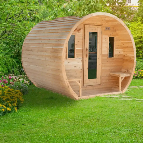 A side view of the Dundalk LeisureCraft Canadian Timber CT Elation Sauna (CTC2424E) in a lush green garden setting, highlighting its curved barrel design.