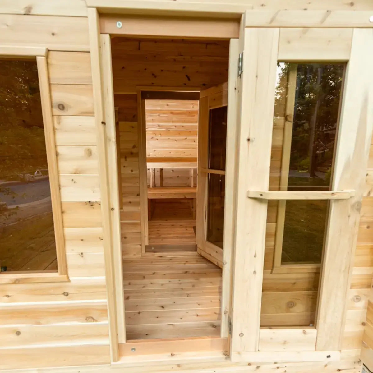 View from the outside of a Dundalk LeisureCraft Canadian Timber Georgian Cabin Sauna with Changeroom (CTC88CE) looking through the doorway and into the sauna.