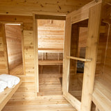 The interior of a Dundalk LeisureCraft Canadian Timber Georgian Cabin Sauna with Changeroom (CTC88CE), showing the open doorway to the sauna area.