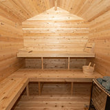 The interior of a Dundalk LeisureCraft Canadian Timber Georgian Cabin Sauna with Changeroom (CTC88CE), showcasing the wooden benches and Harvia electric heater.