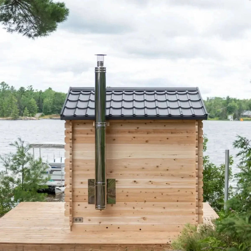 Back exterior view of the Dundalk LeisureCraft Canadian Timber Georgian Cabin Sauna (CTC88E) showing the wood stove chimney.