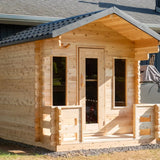 Front view of a Dundalk LeisureCraft Canadian Timber Georgian Cabin Sauna with Porch (CTC88PE), showing the front porch and door.