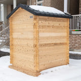 Side exterior view of a Dundalk LeisureCraft Canadian Timber Granby Cabin Sauna (CTC66E) on a snow-covered lawn.
