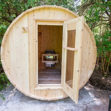 The exterior of a Dundalk LeisureCraft Canadian Timber Harmony Barrel Sauna (CTC22E) with the glass door open, showing the inside and the front benches.