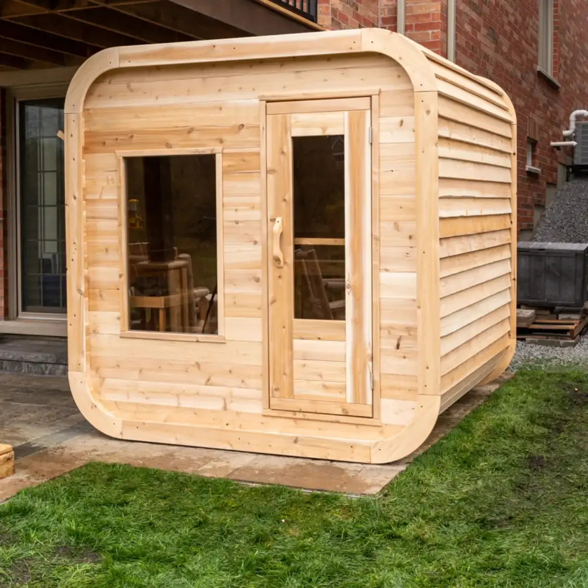 A side exterior view of the Dundalk LeisureCraft Canadian Timber Luna Sauna (CTC22LU), showing the rounded shape and horizontal cedar siding.