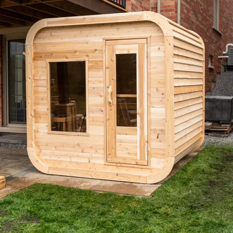 A side exterior view of the Dundalk LeisureCraft Canadian Timber Luna Sauna (CTC22LU), showing the rounded shape and horizontal cedar siding.