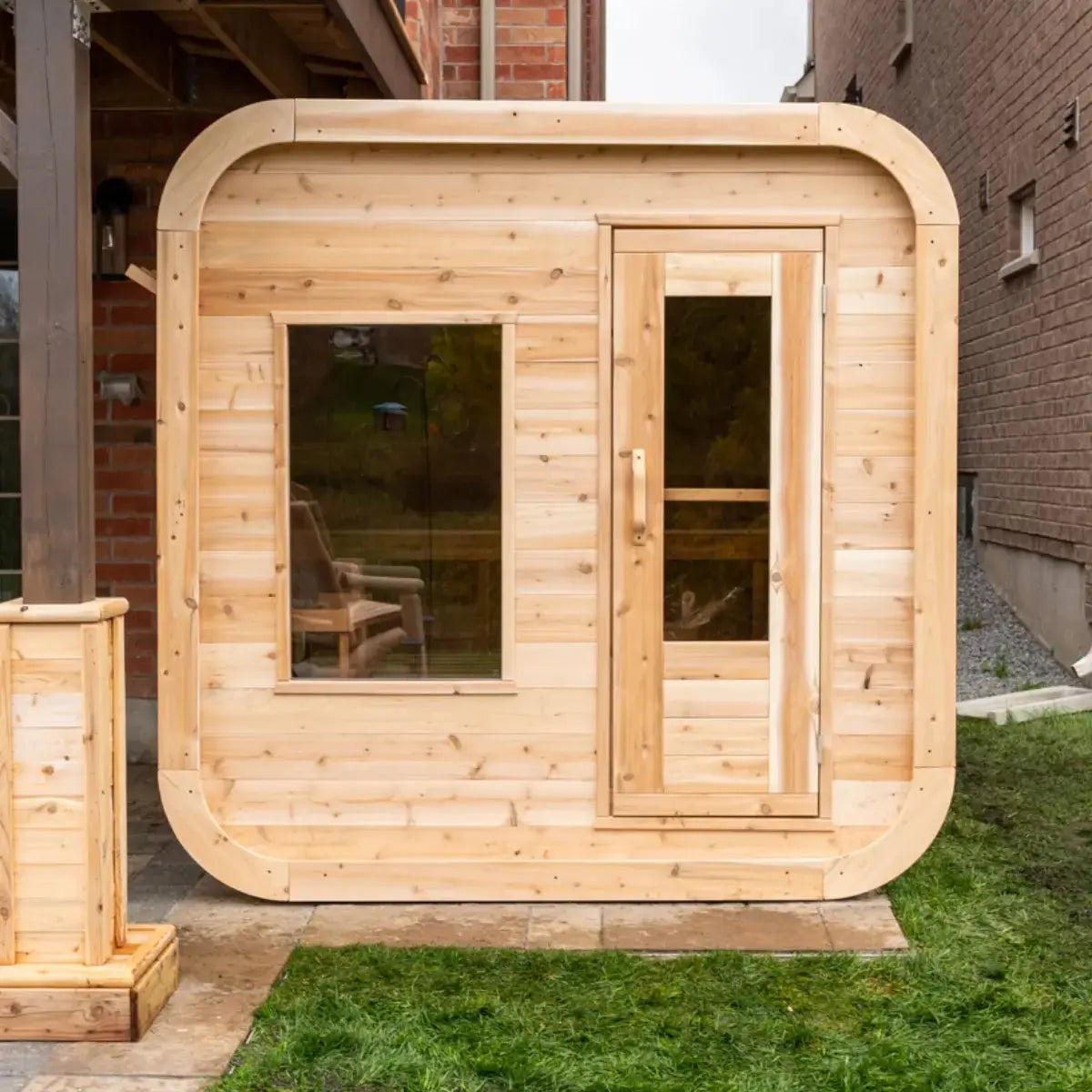 Front exterior view of a Dundalk LeisureCraft Canadian Timber Luna Sauna (CTC22LU), highlighting the rounded corners and front door.