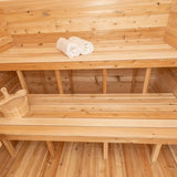 The interior of a Dundalk LeisureCraft Canadian Timber Luna Sauna (CTC22LU), showing the multi-level benches with towels.