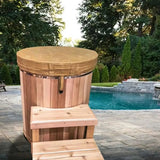 A tan insulated vinyl tub cover (SKU: 730123) on a wooden cold plunge tub, designed to keep water temperature stable.