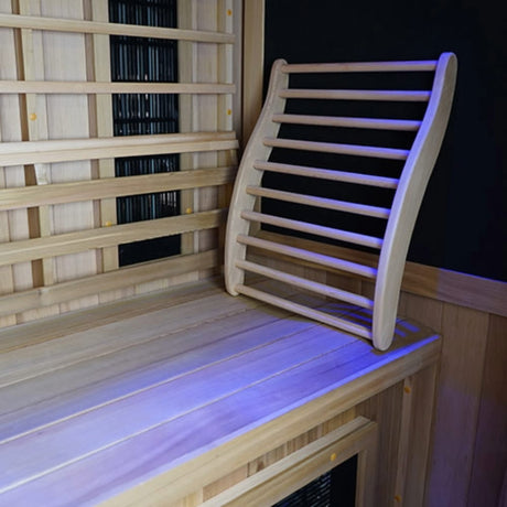 Finnmark FD-1 infrared sauna interior showing Western Canadian cedar backrest with chromotherapy blue lighting and carbon 360 heater panels.