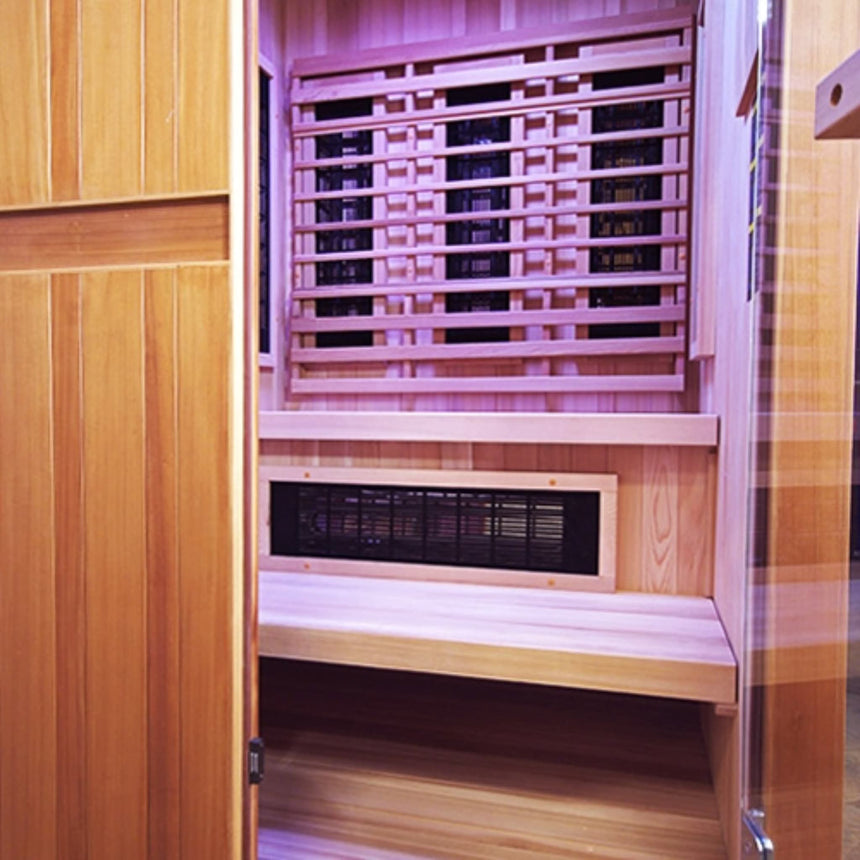 Finnmark FD-4 Trinity sauna view through glass door showing chromotherapy lighting, infrared heater panel and cedar benches.