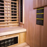 Finnmark FD-4 Trinity sauna interior corner showing Spectrum Plus UL listed infrared heater panel and cedar bench construction.