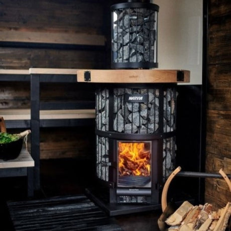 Harvia Legend 240 Green Flame stove in a modern sauna interior, showing firebox and the optional WL300 smoke pipe cover accessory.