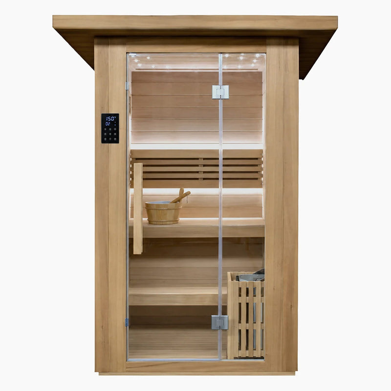 Front view of the Revive 2 Person Traditional Sauna in thermo-treated hemlock with a full-height glass door, exterior touchscreen control panel, bucket and ladle on the upper bench and the heater behind a wooden guard