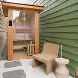 Revive 2 Person Traditional Sauna installed outdoors on white gravel in a narrow side yard