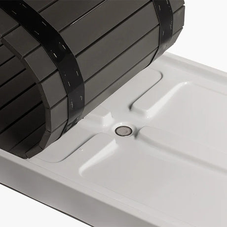 Revive Acrylic Basin with its composite deck slats rolled back, showing the drain with a mesh strainer in the basin floor