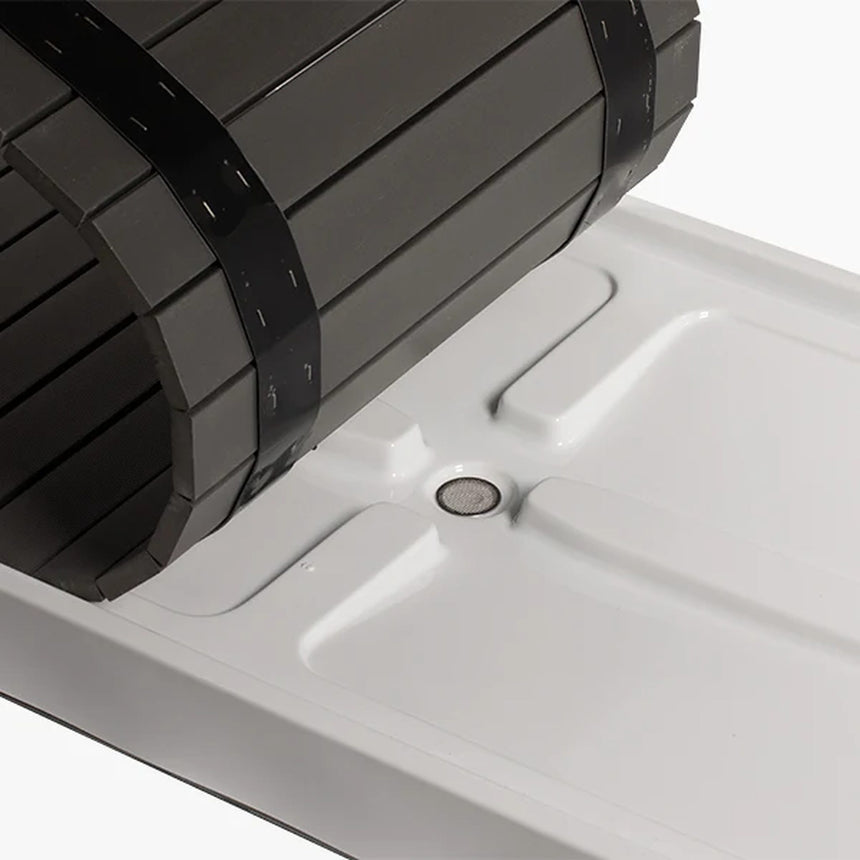 Revive Acrylic Basin with its composite deck slats rolled back, showing the drain with a mesh strainer in the basin floor