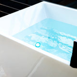Water in the Revive Acrylic Plunge lit blue by its color-changing LED tub light