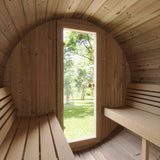Interior view of the SaunaLife E8 Barrel Sauna looking out the door to a green outdoor landscape.
