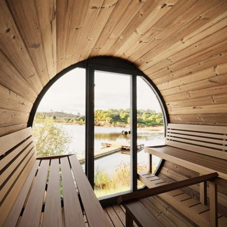 SaunaLife Model E8W premium outdoor sauna interior with panoramic glass front overlooking a lake and wood benches.