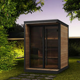 SaunaLife Model GL4 4-person Garden Luxury outdoor sauna at night with LED eaves lighting, bronze glass front and black trim.