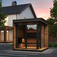 SaunaLife Model GL6 6-person Garden Luxury outdoor sauna at dusk with full bronze glass front, black trim and thermo-spruce construction.